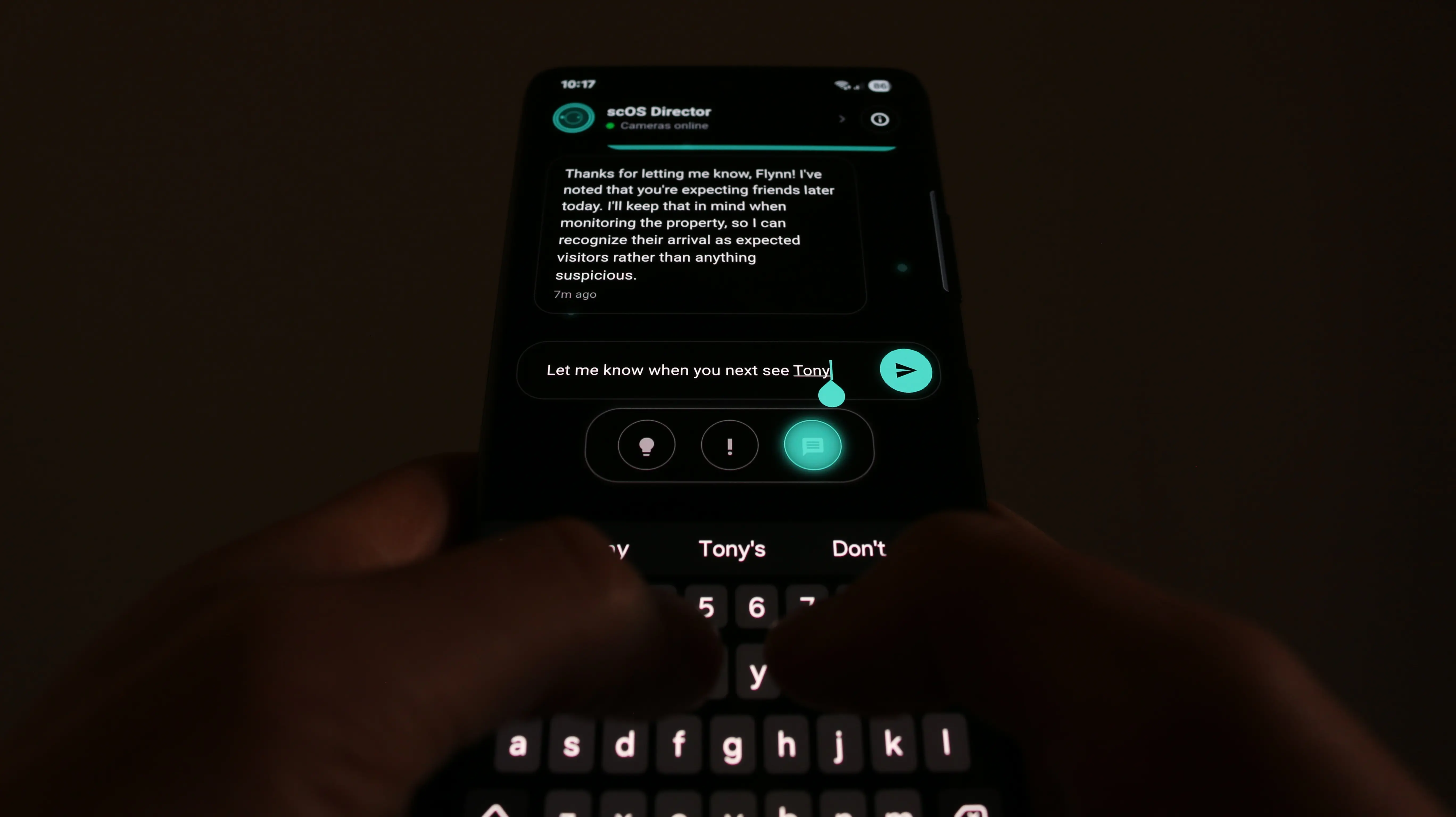 Hands typing a message to scOS Director — telling it to notify when a visitor returns